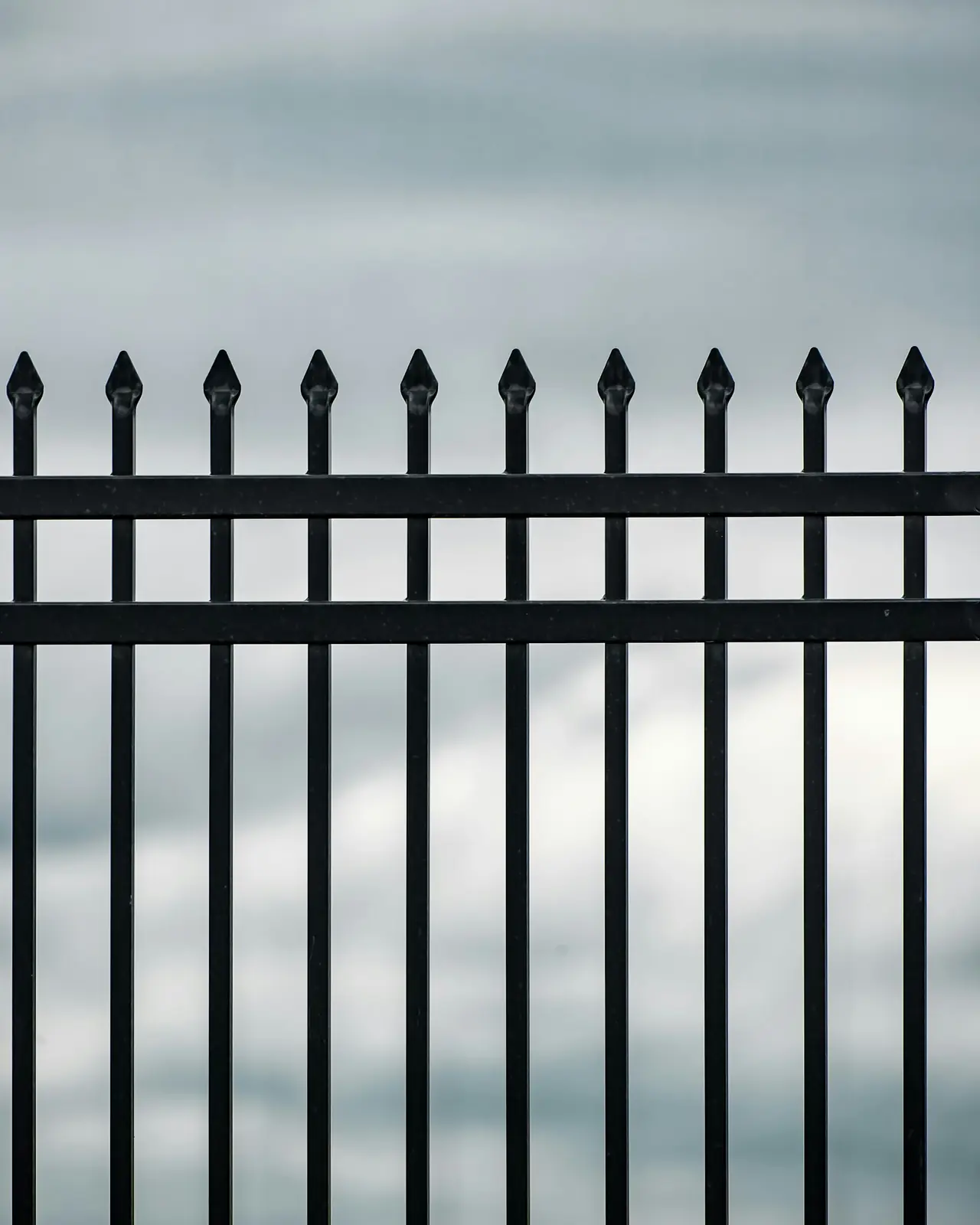 Black steel security fencing with spear-top pickets