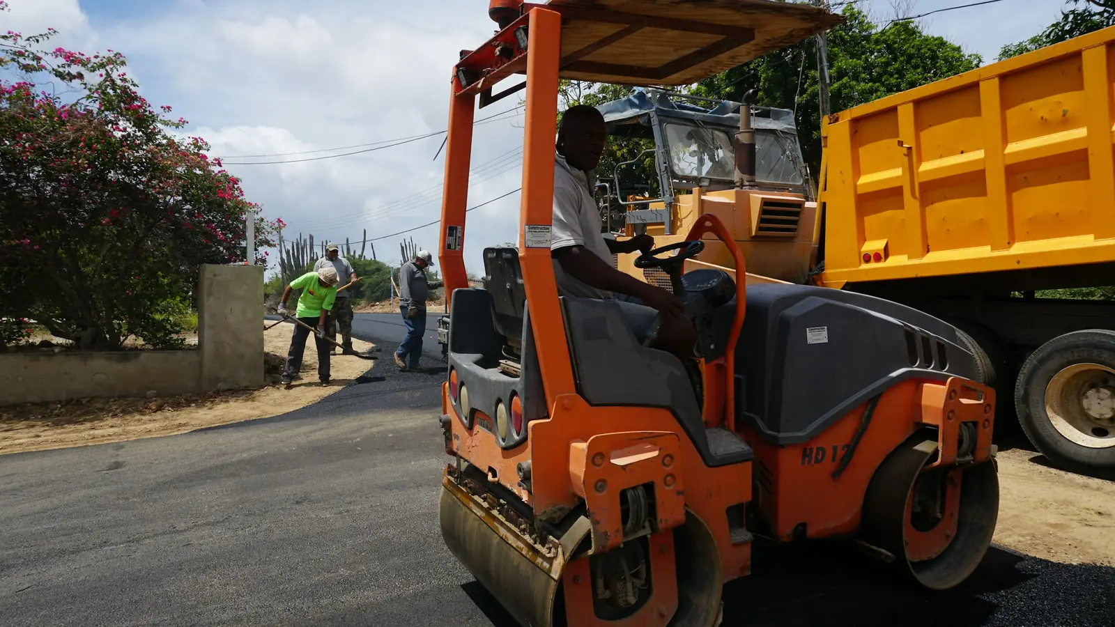 Road roller compacting freshly laid asphalt
